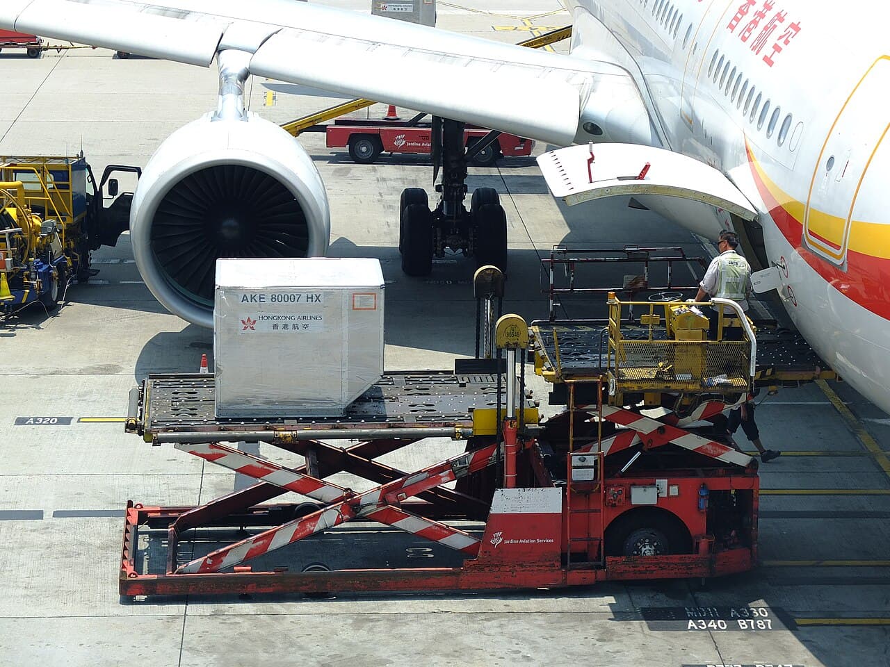 Cargo container being loaded into a passenger jet